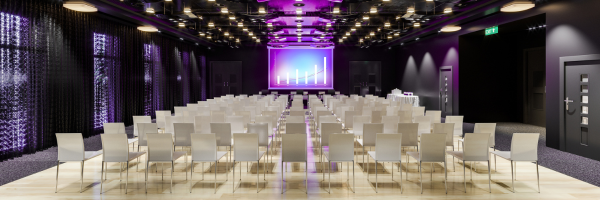 Empty conference room for large meeting, white chairs in rows and a large screen in the front,