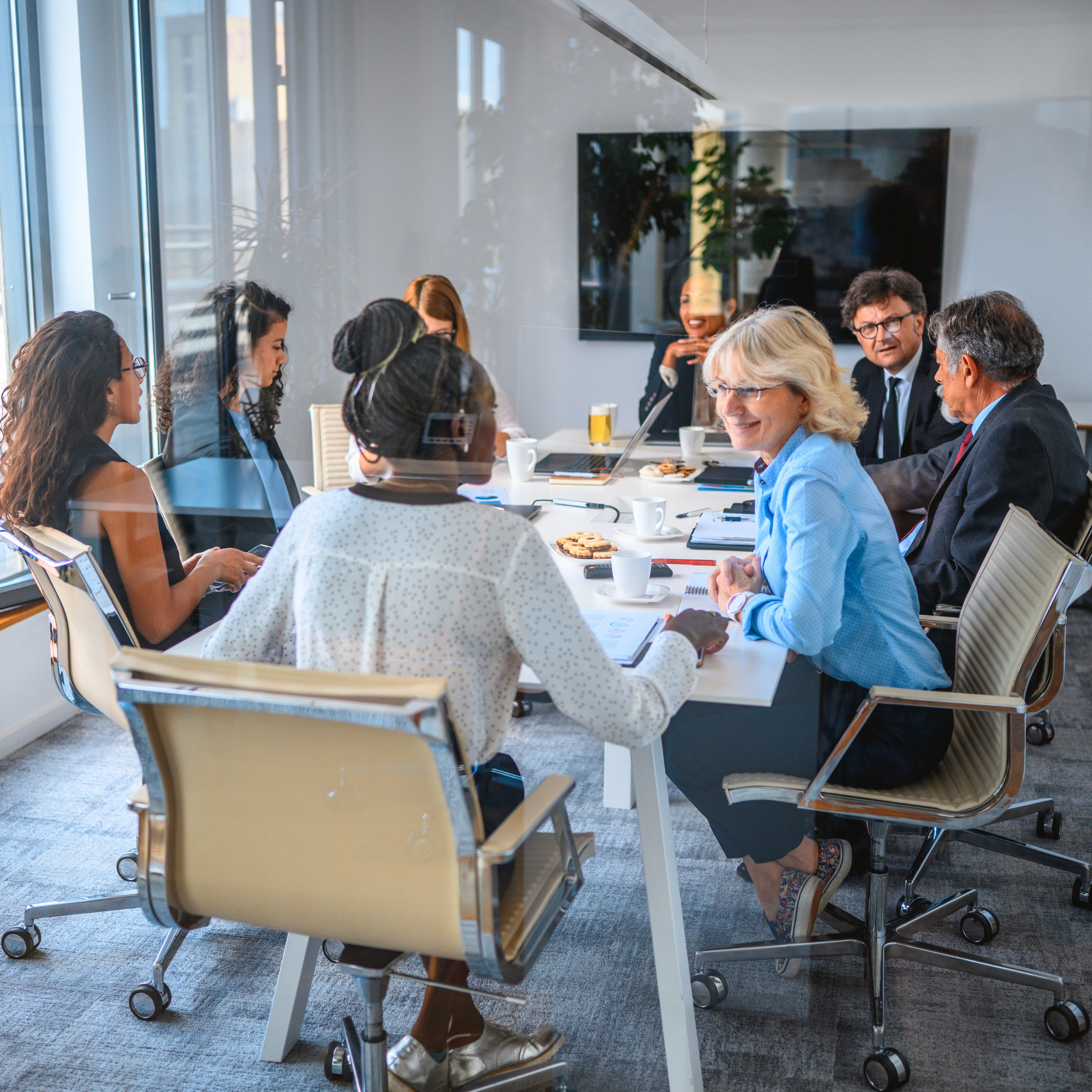 Group of professionals around a conference room table.